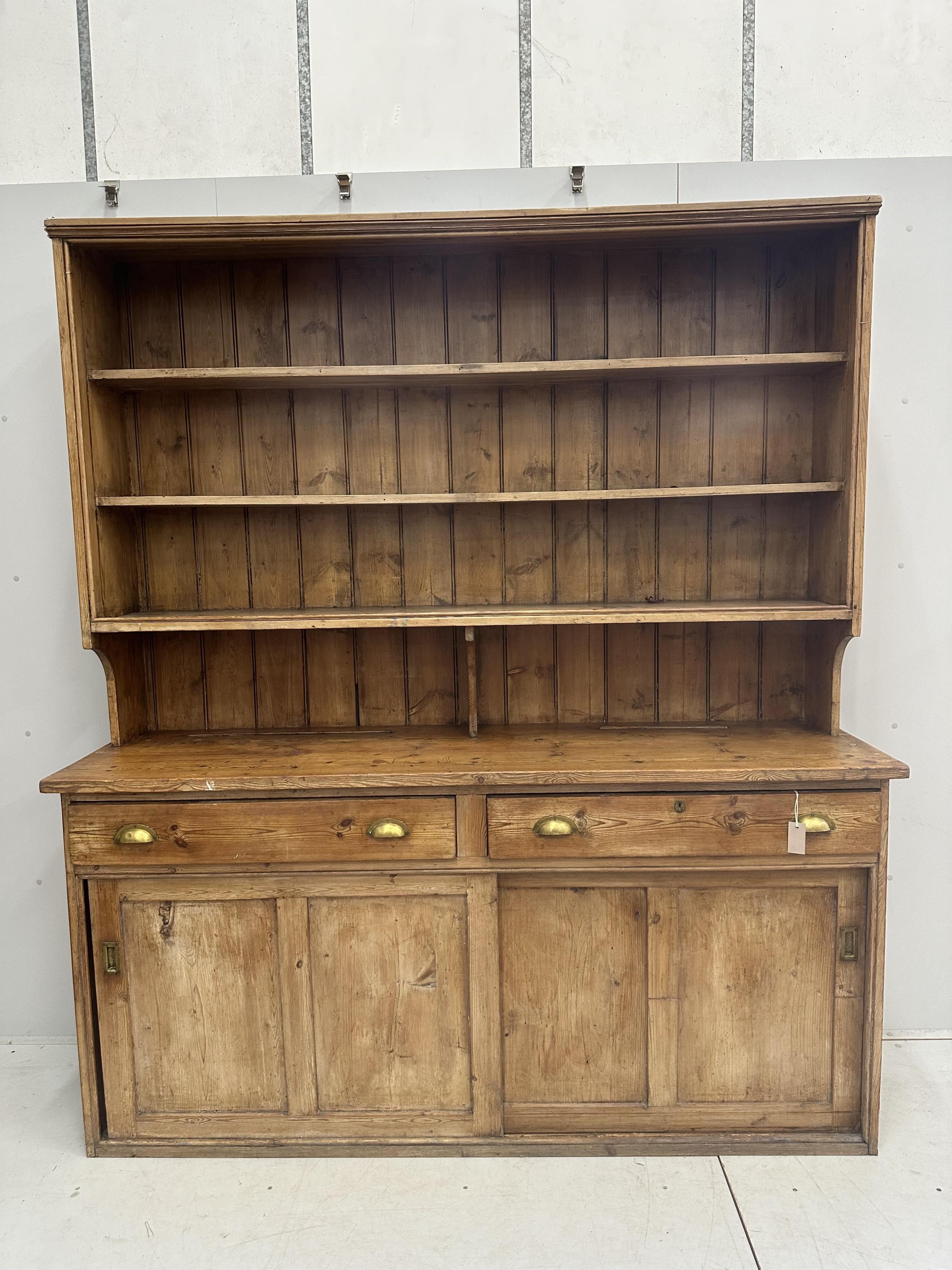 A Victorian pine dresser with boarded rack, width 189cm, depth 51cm, height 216cm. Condition - poor to fair